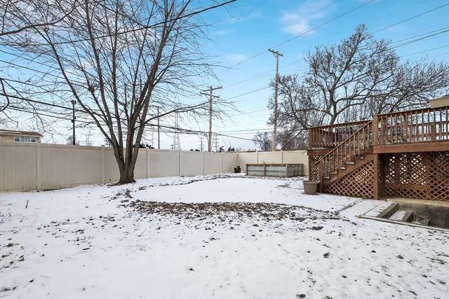 a house covered with snow in front of house