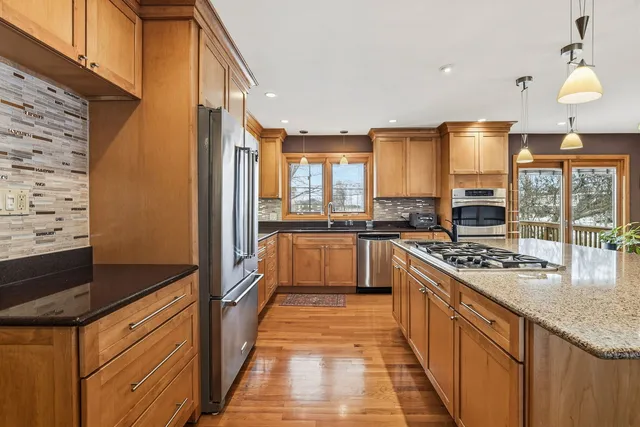 a kitchen with stainless steel appliances granite countertop a stove and a sink