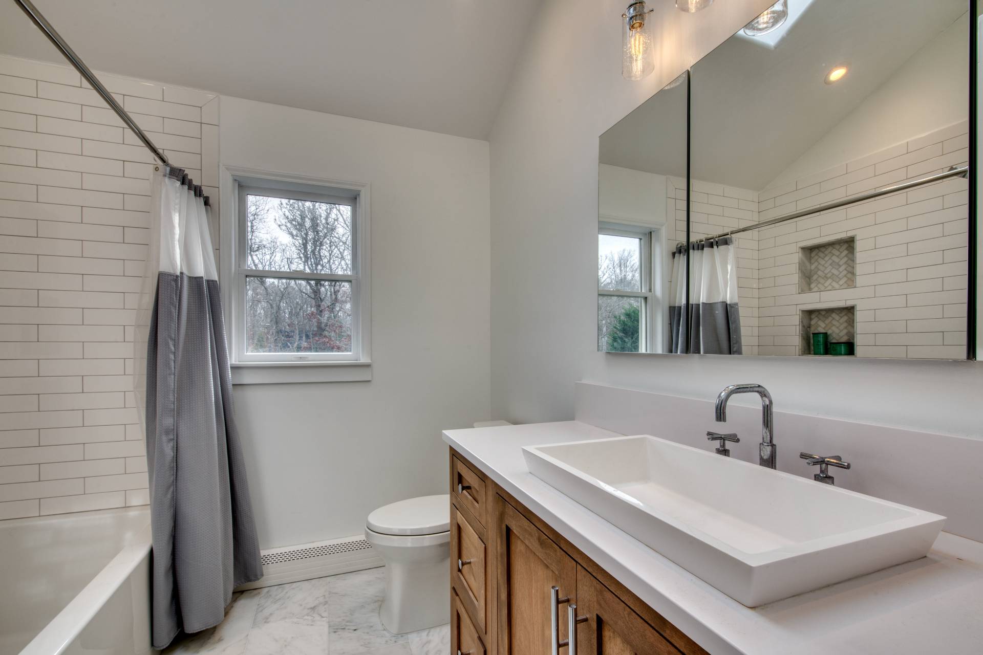 36 Barnes Avenue East Hampton, NY 11937 - Photo 6 of 13 a bathroom with a toilet sink and mirror