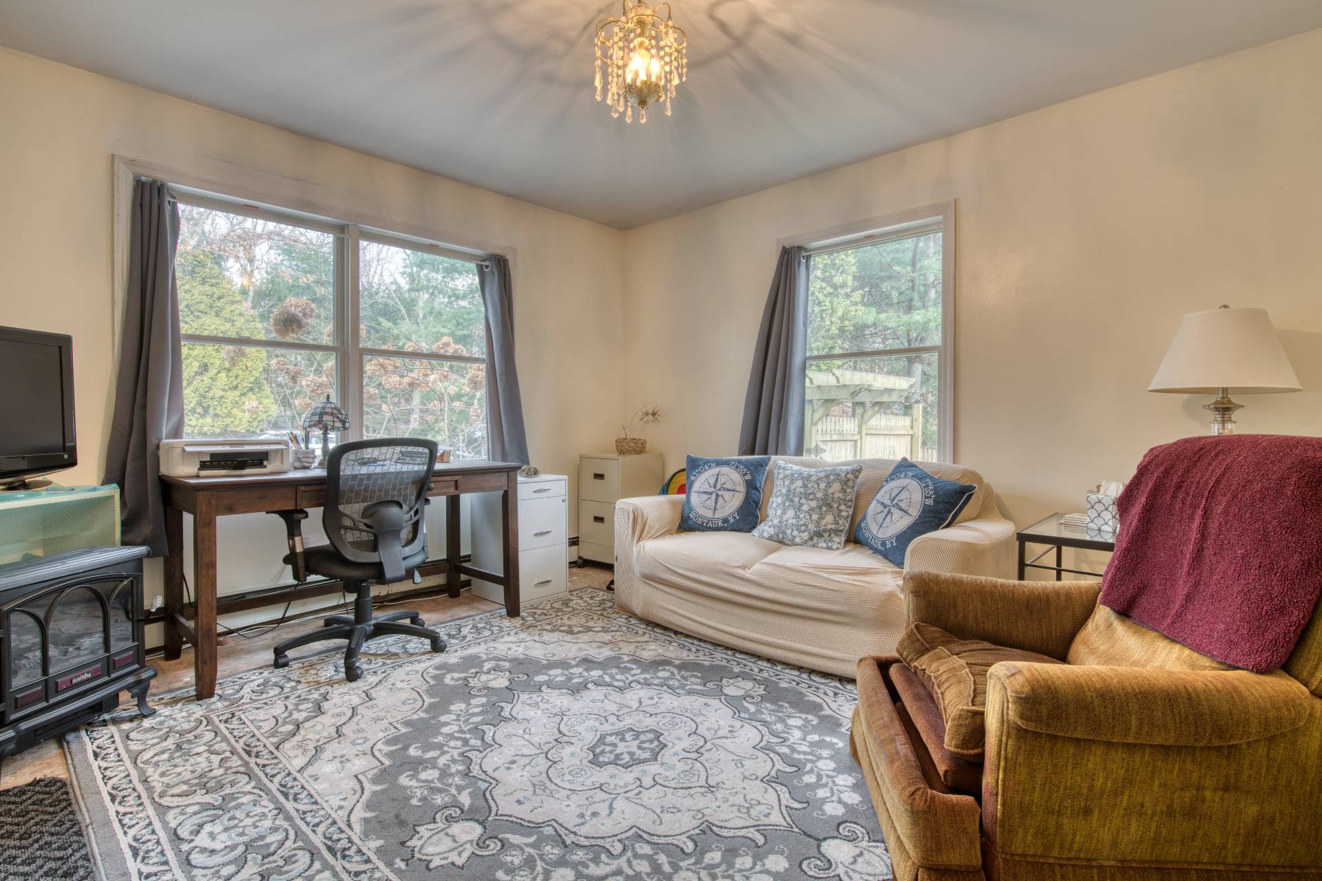 36 Barnes Avenue East Hampton, NY 11937 - Photo 9 of 13 a living room with furniture a flat screen tv and a large window