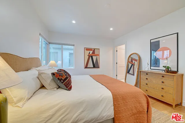 a bedroom with bed and lamp