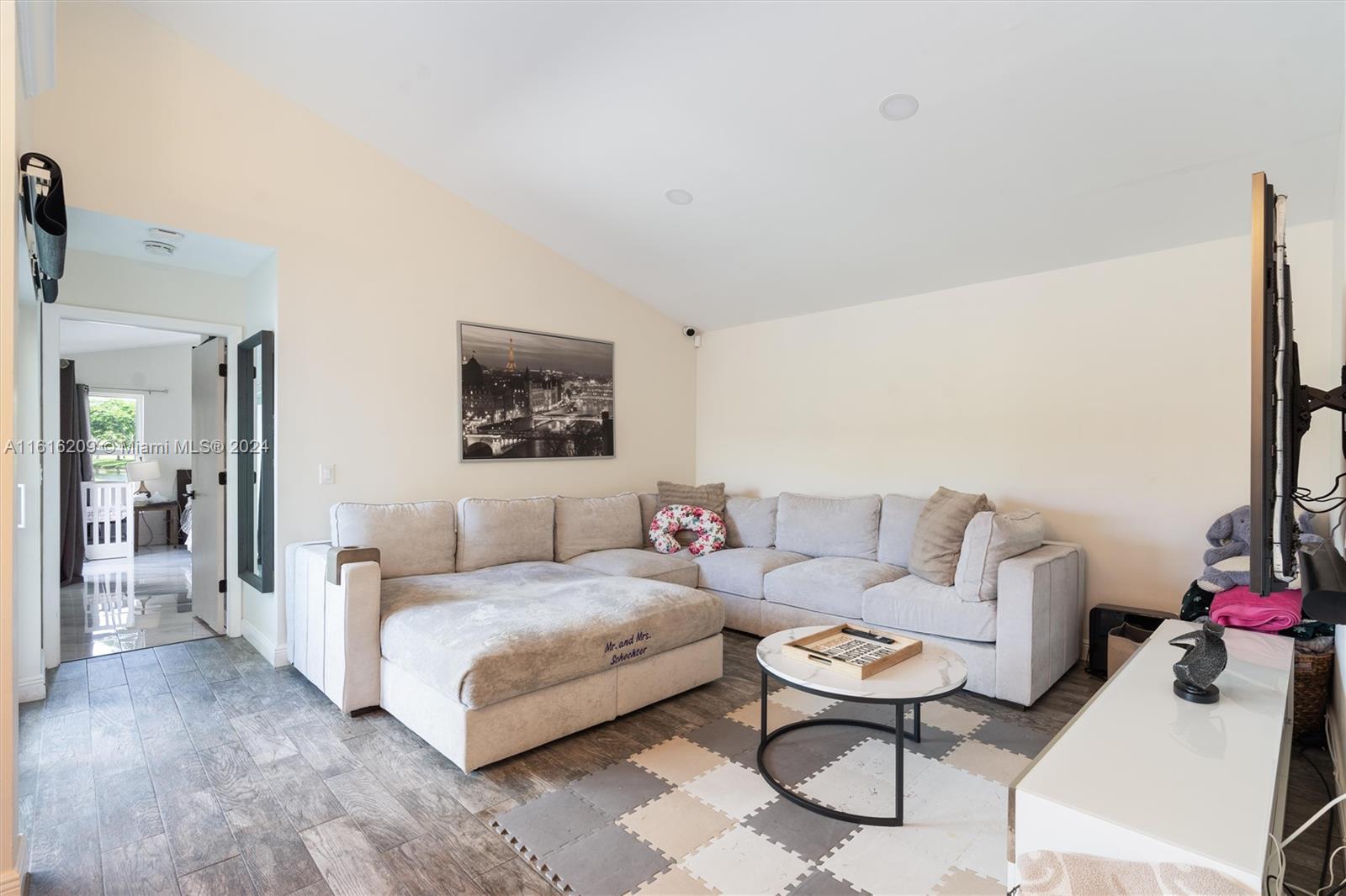 22397 Swordfish Drive Boca Raton, FL 33428 - Photo 3 of 20 a living room with furniture and a flat screen tv