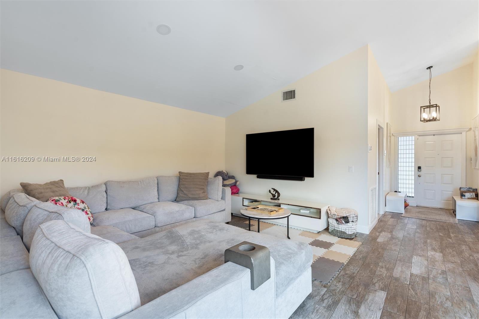 22397 Swordfish Drive Boca Raton, FL 33428 - Photo 4 of 20 a living room with furniture and a flat screen tv