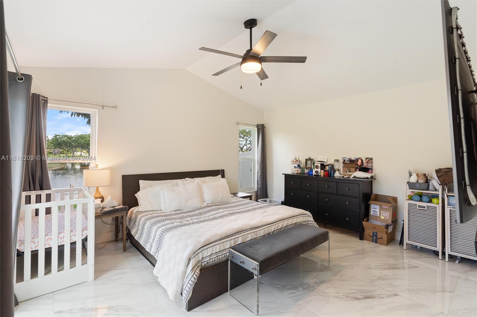 22397 Swordfish Drive Boca Raton, FL 33428 - Photo 10 of 20 a bedroom with a bed and a chandelier