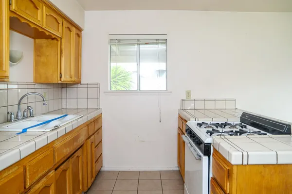 a kitchen with a sink stove and cabinets