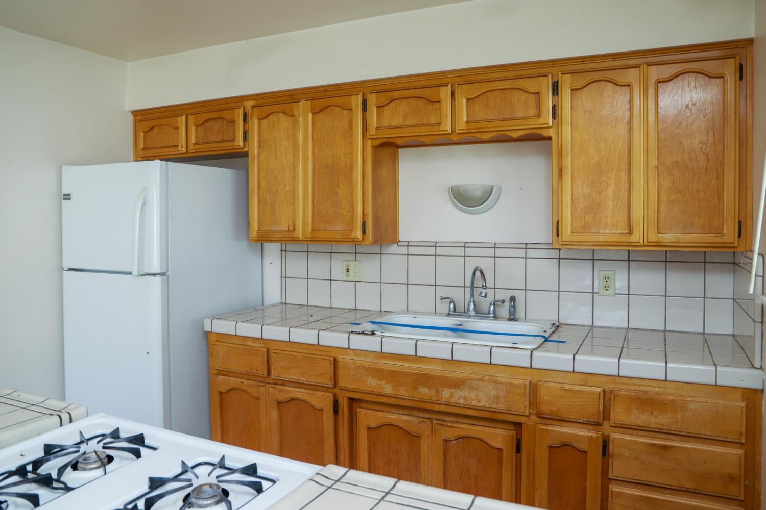 223 South Kady Avenue Reedley, CA 93654 - Photo 10 of 24 a kitchen with a sink and cabinets