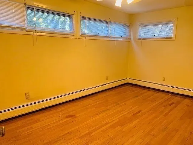 a view of a room with wooden floor