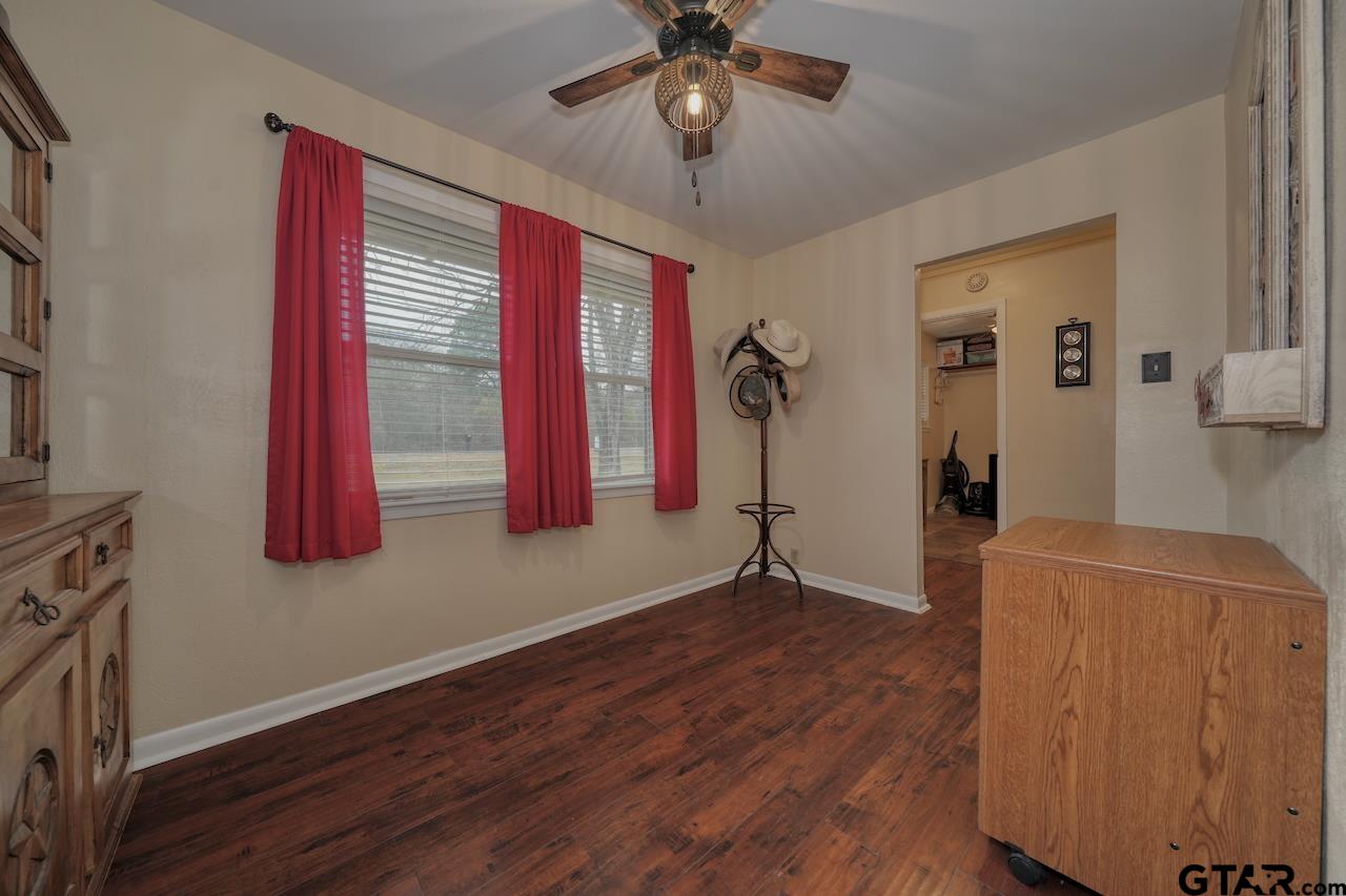 11656 Constantine Avenue Tyler, TX 75708 - Photo 13 of 26 a view of a livingroom with wooden floor and a ceiling fan