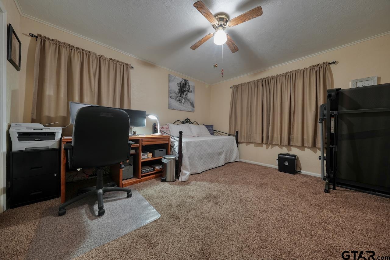 11656 Constantine Avenue Tyler, TX 75708 - Photo 21 of 26 a bedroom with a bed and a chandelier