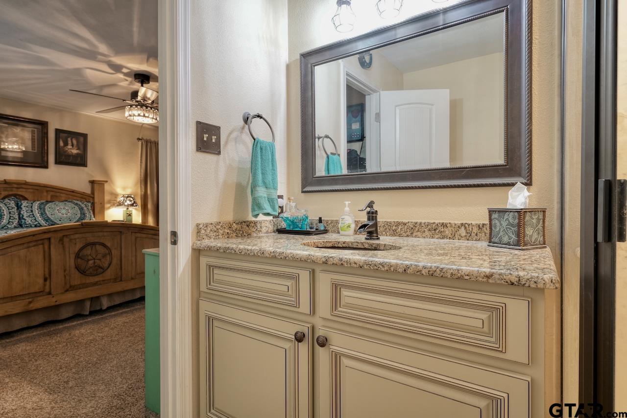 11656 Constantine Avenue Tyler, TX 75708 - Photo 25 of 26 a bathroom with a sink and a mirror