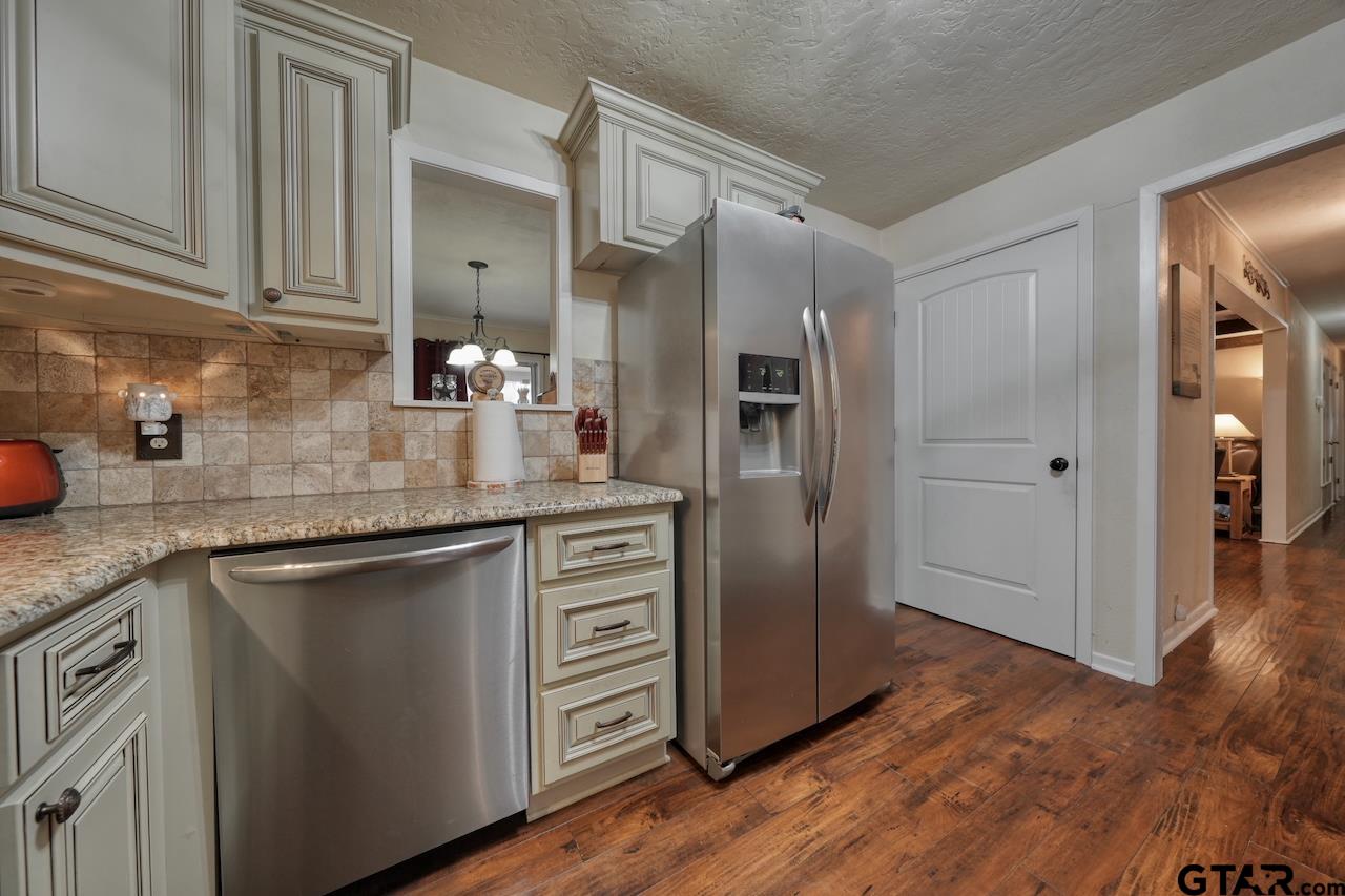11656 Constantine Avenue Tyler, TX 75708 - Photo 10 of 26 a kitchen with stainless steel appliances granite countertop a refrigerator and a sink