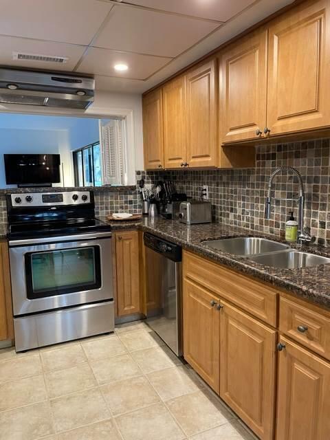 13400 Polo Road West Wellington, FL 33414 - Photo 6 of 16 a kitchen with granite countertop a stove top oven microwave and cabinets