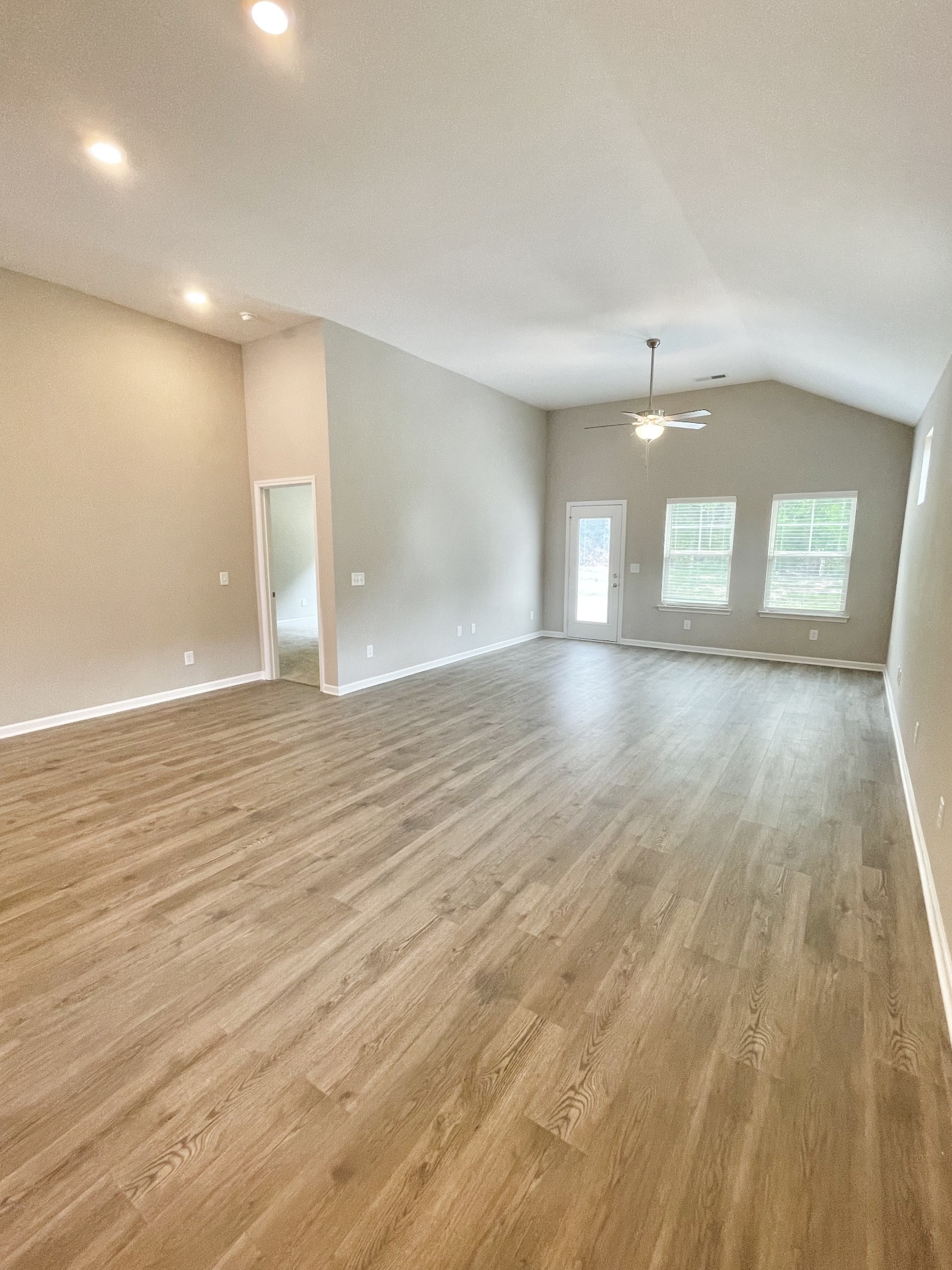710 Rex Dr Spring Hill Spring Hill, TN 37174 - Photo 11 of 21 an empty room with wooden floor and windows