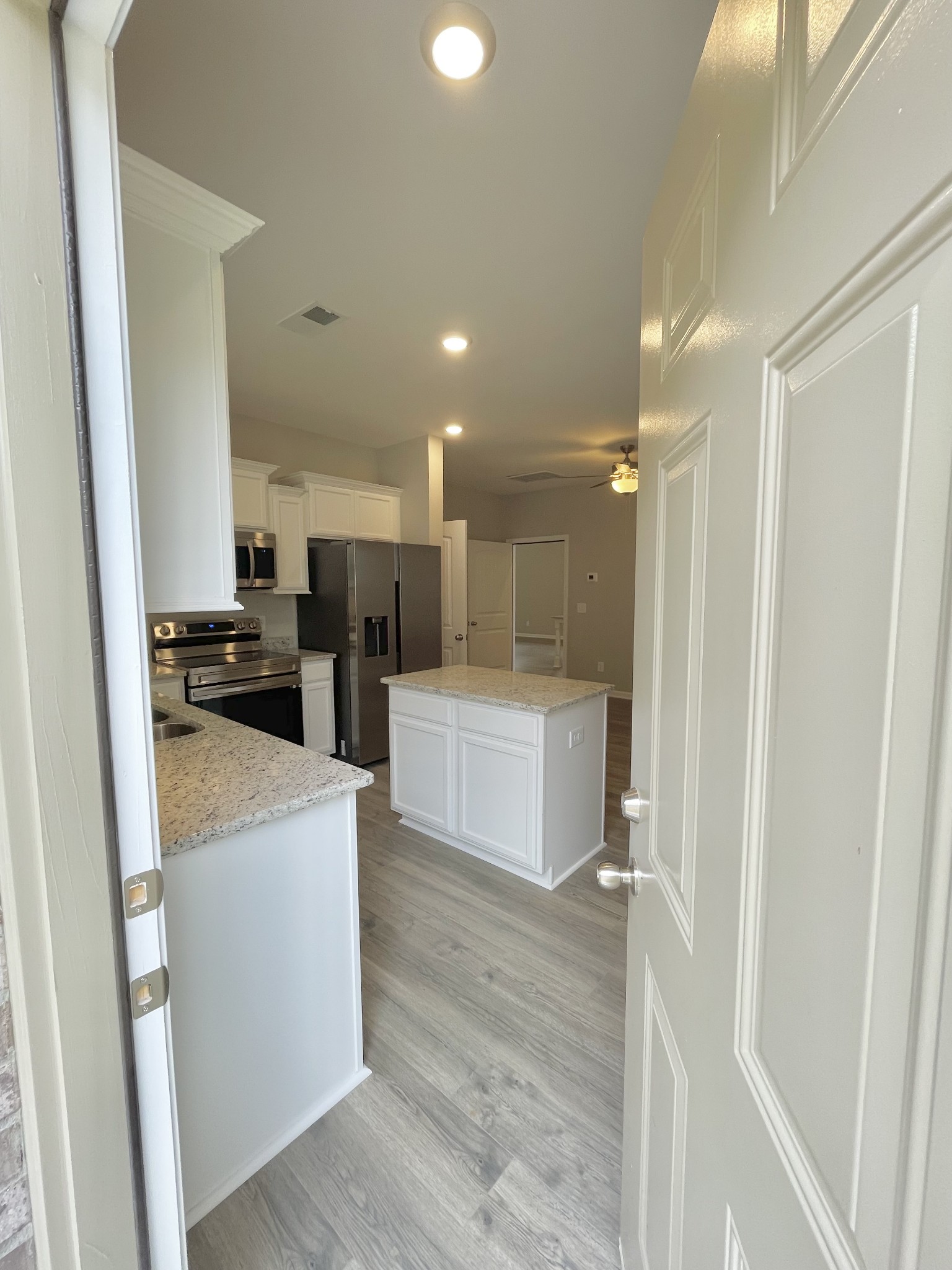 710 Rex Dr Spring Hill Spring Hill, TN 37174 - Photo 20 of 21 a kitchen with stainless steel appliances kitchen island a stove a refrigerator a sink and a refrigerator