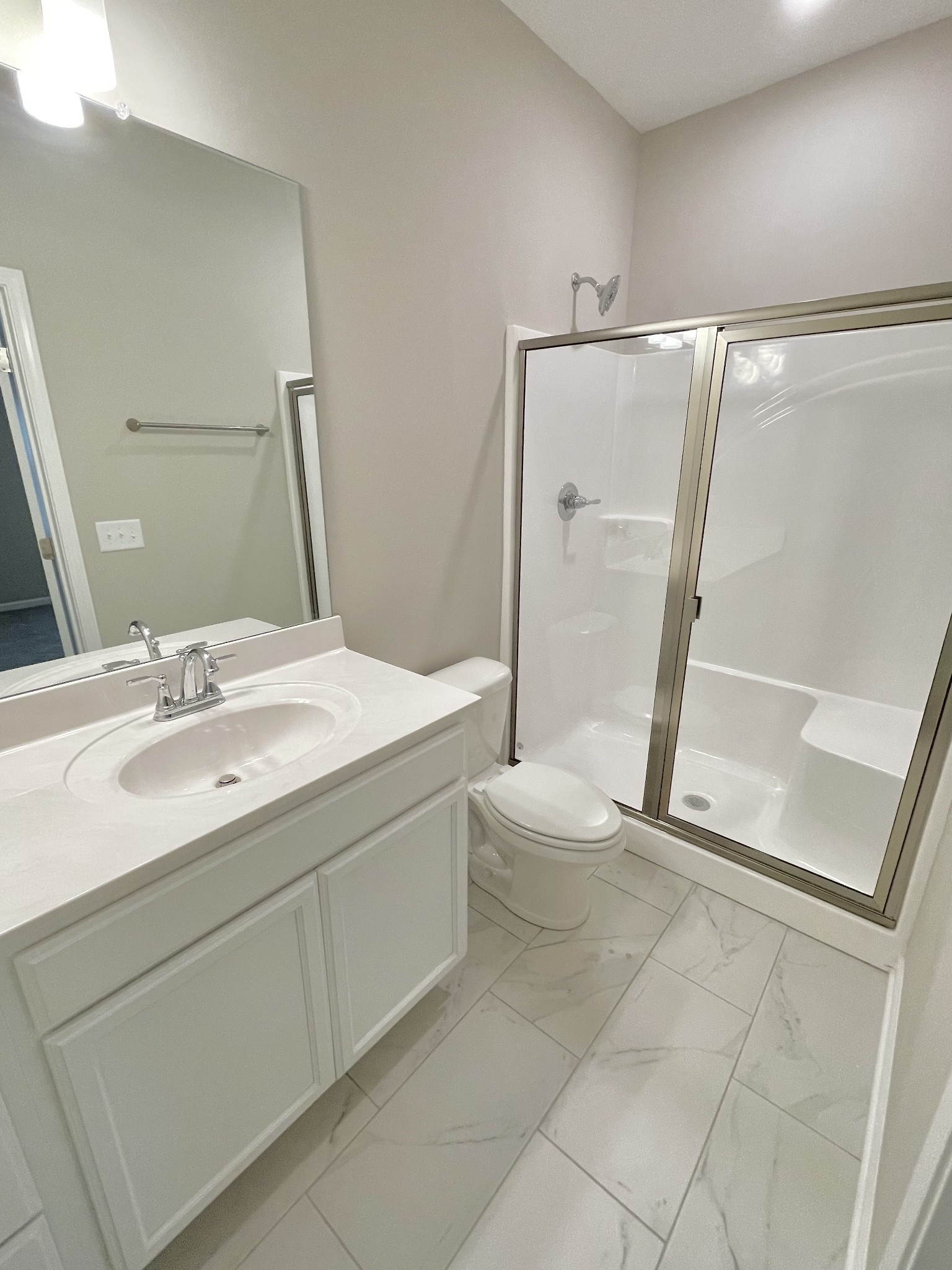 710 Rex Dr Spring Hill Spring Hill, TN 37174 - Photo 21 of 21 a bathroom with a sink a toilet a mirror and shower