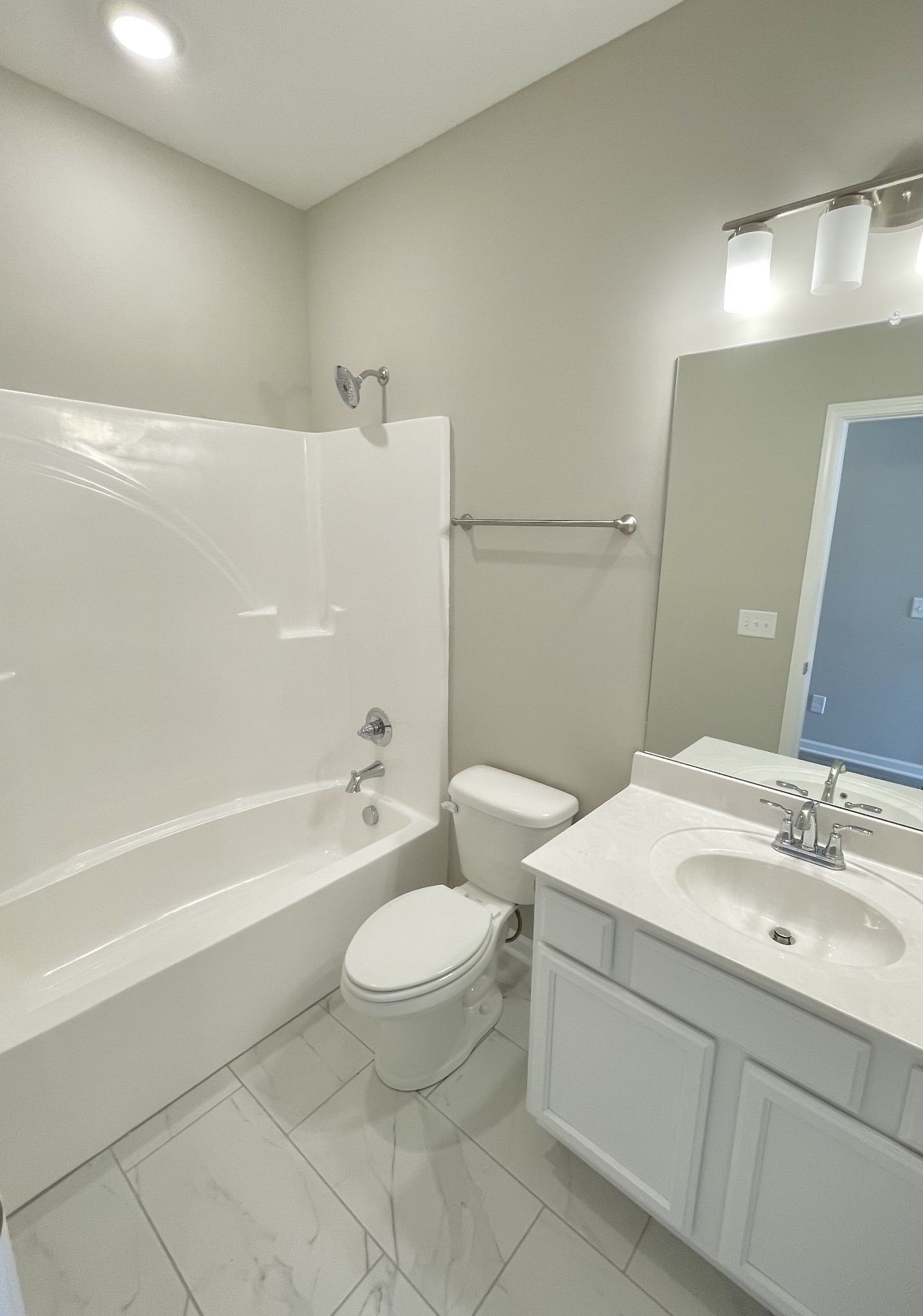 710 Rex Dr Spring Hill Spring Hill, TN 37174 - Photo 5 of 21 a bathroom with a sink a toilet a mirror and bathtub