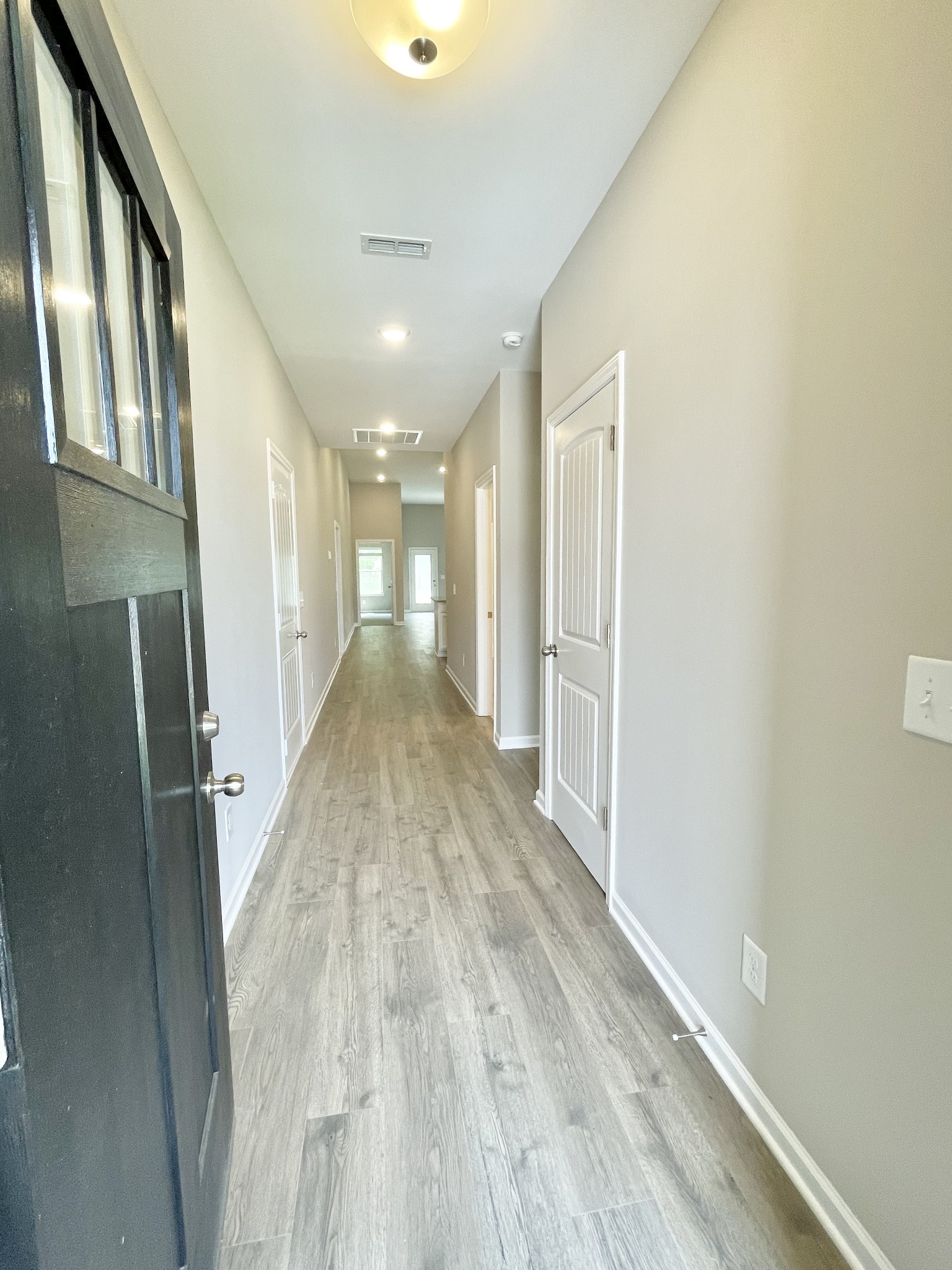 710 Rex Dr Spring Hill Spring Hill, TN 37174 - Photo 7 of 21 a view of a hallway with wooden floor