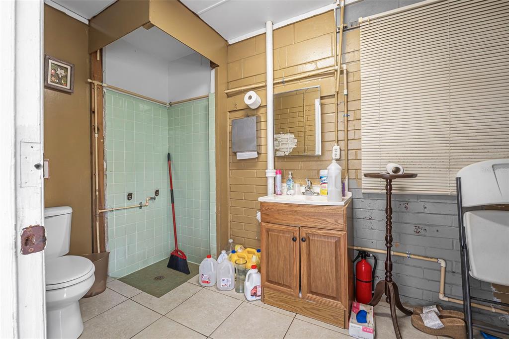 2620 Doyle Road Deltona, FL 32738 - Photo 13 of 54 a bathroom with a toilet and a shower