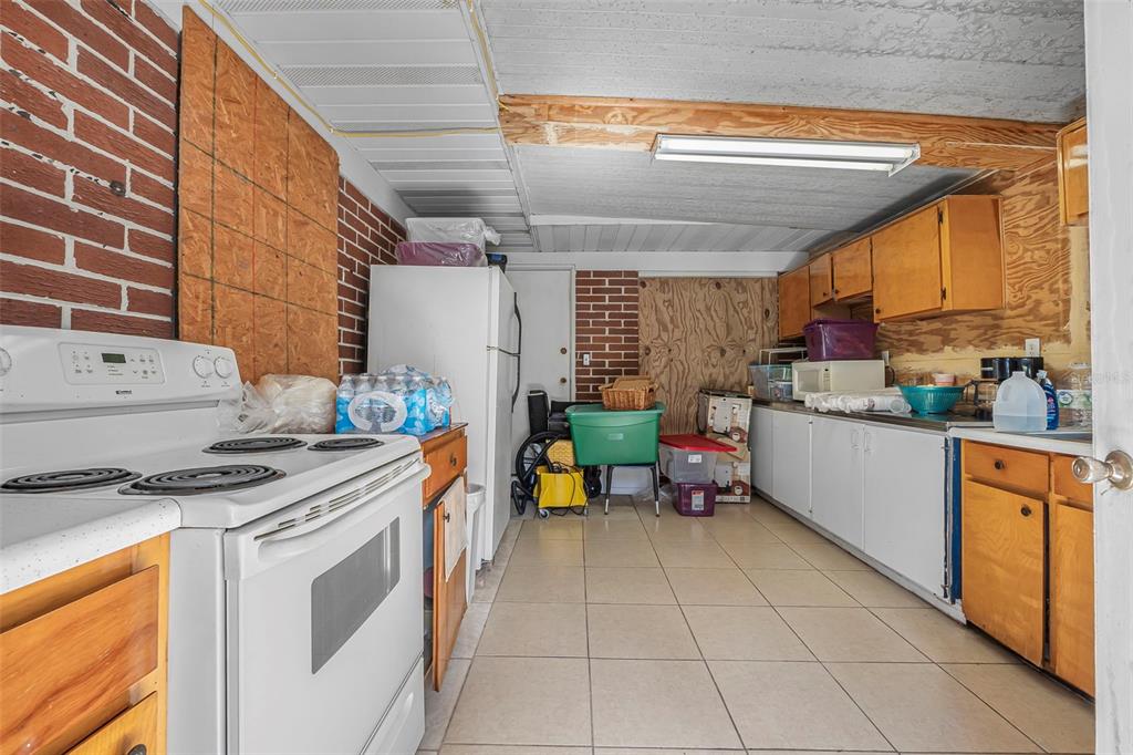 2620 Doyle Road Deltona, FL 32738 - Photo 15 of 54 a kitchen with stainless steel appliances granite countertop a stove a sink and a microwave