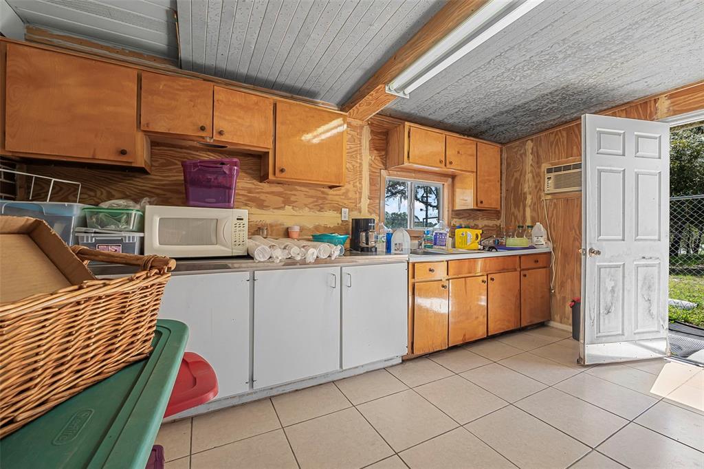 2620 Doyle Road Deltona, FL 32738 - Photo 16 of 54 a kitchen with white cabinets and white appliances