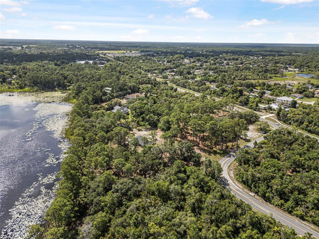 2620 Doyle Road Deltona, FL 32738 - Photo 26 of 54 an aerial view of residential houses with outdoor space and trees
