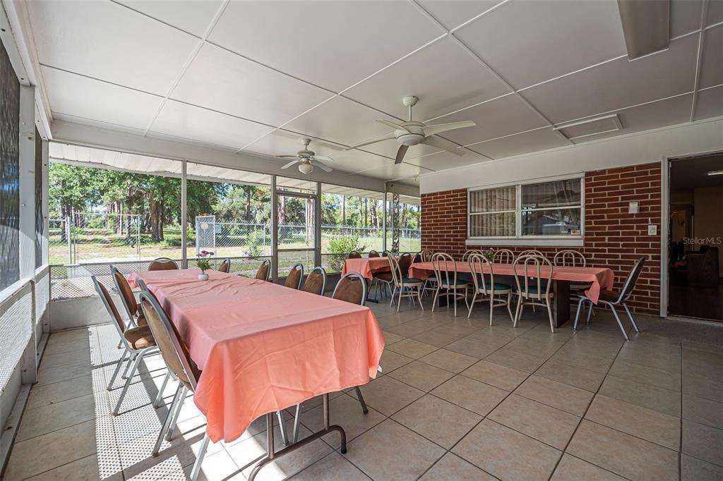 2620 Doyle Road Deltona, FL 32738 - Photo 30 of 54 a dinning table and chairs in the outdoor room