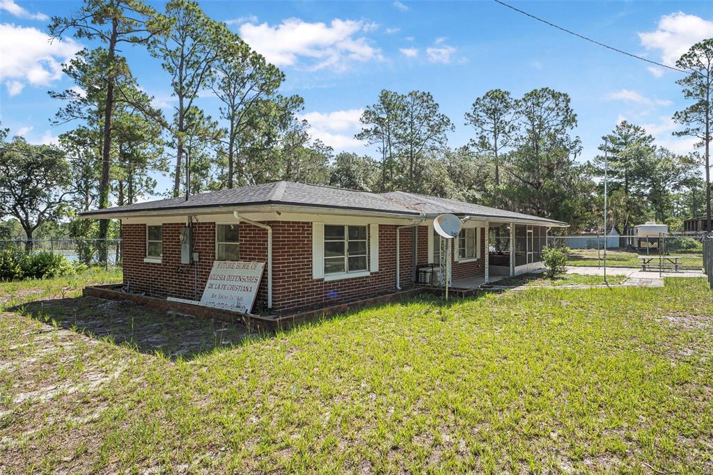 2620 Doyle Road Deltona, FL 32738 - Photo 35 of 54 a view of a house with a yard