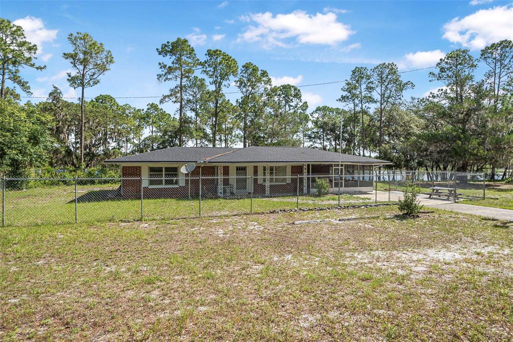 2620 Doyle Road Deltona, FL 32738 - Photo 40 of 54 a view of a house with a yard