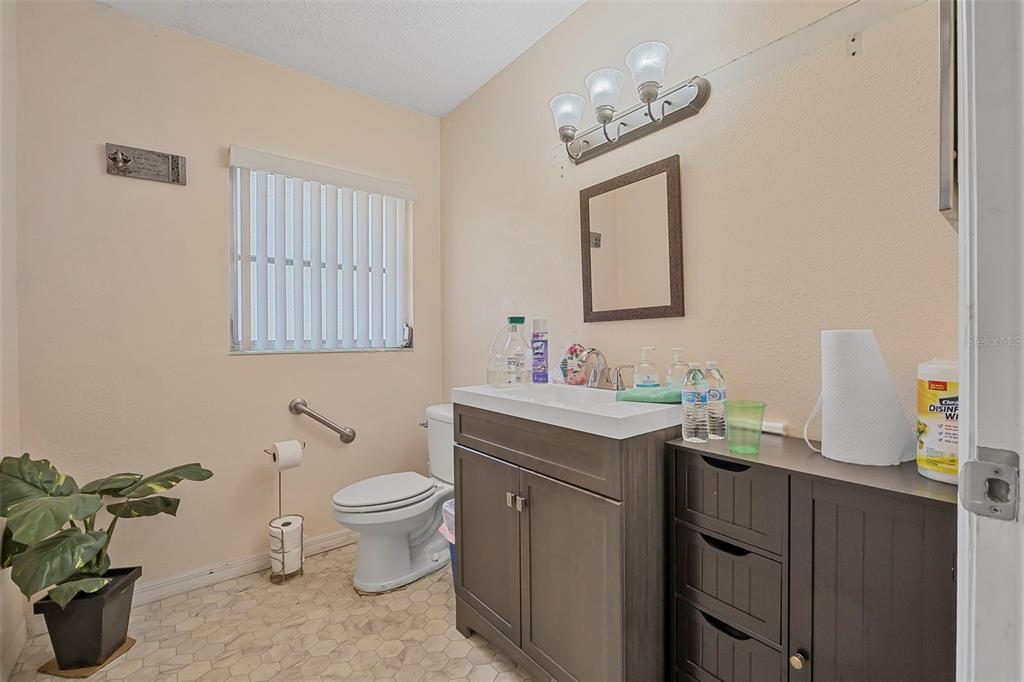 2620 Doyle Road Deltona, FL 32738 - Photo 7 of 54 a bathroom with a toilet sink and mirror