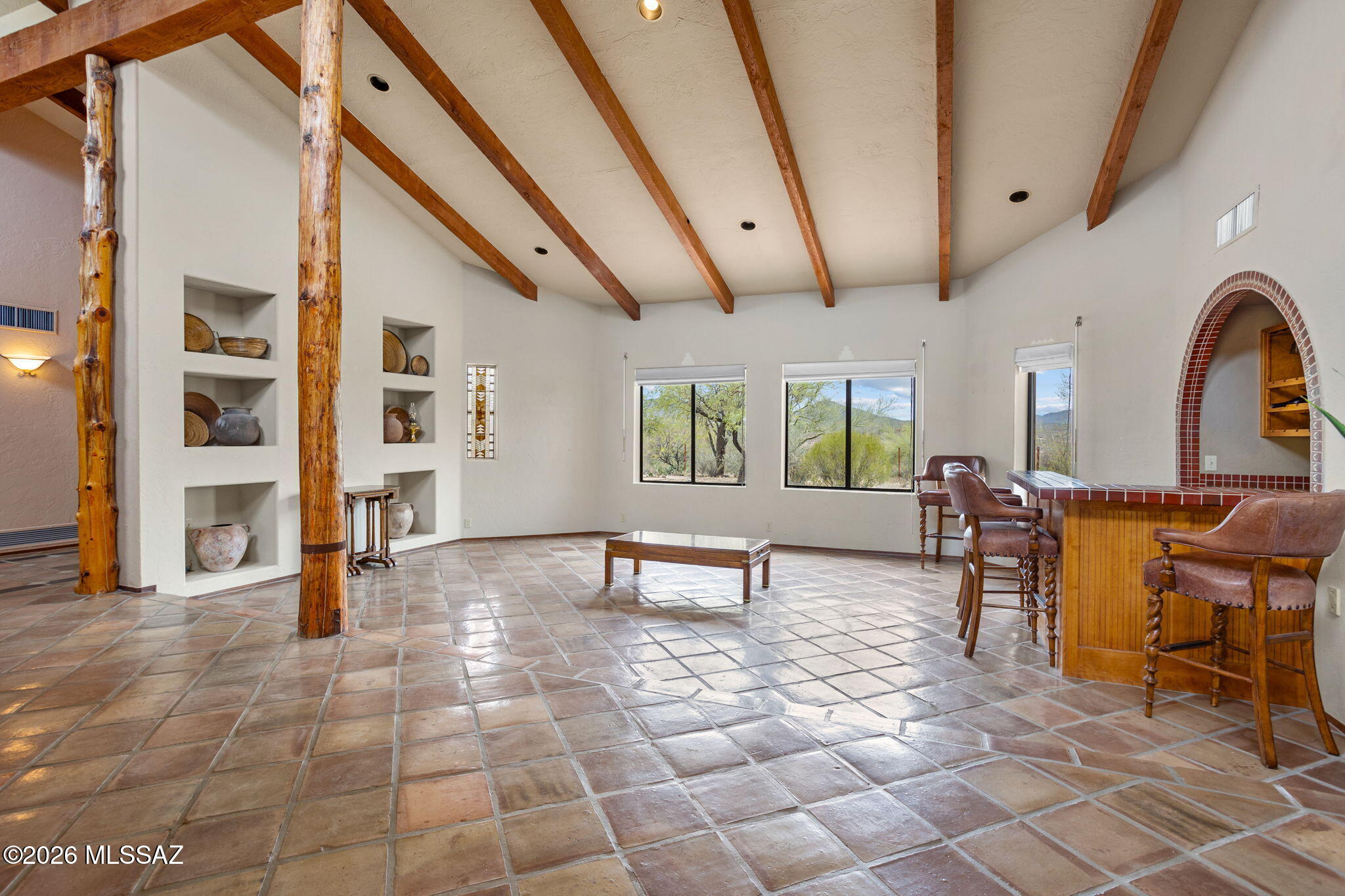 7171 South X9 Ranch Road Vail, AZ 85641 - Photo 8 of 50 Vaulted ceiling, all tile flooring. Decor niches. Beams from Mt Lemmon! Nesting game tables incl.
