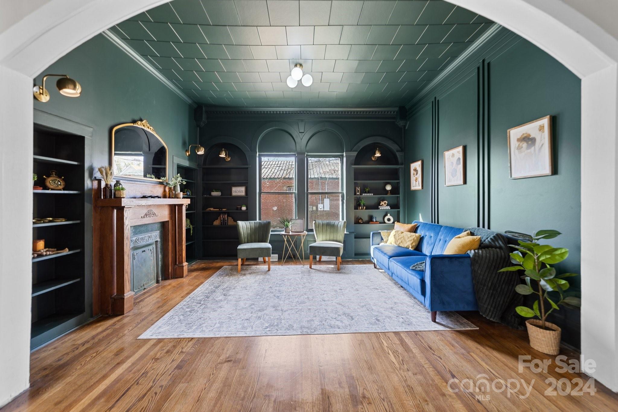 a living room filled with furniture and a potted plant