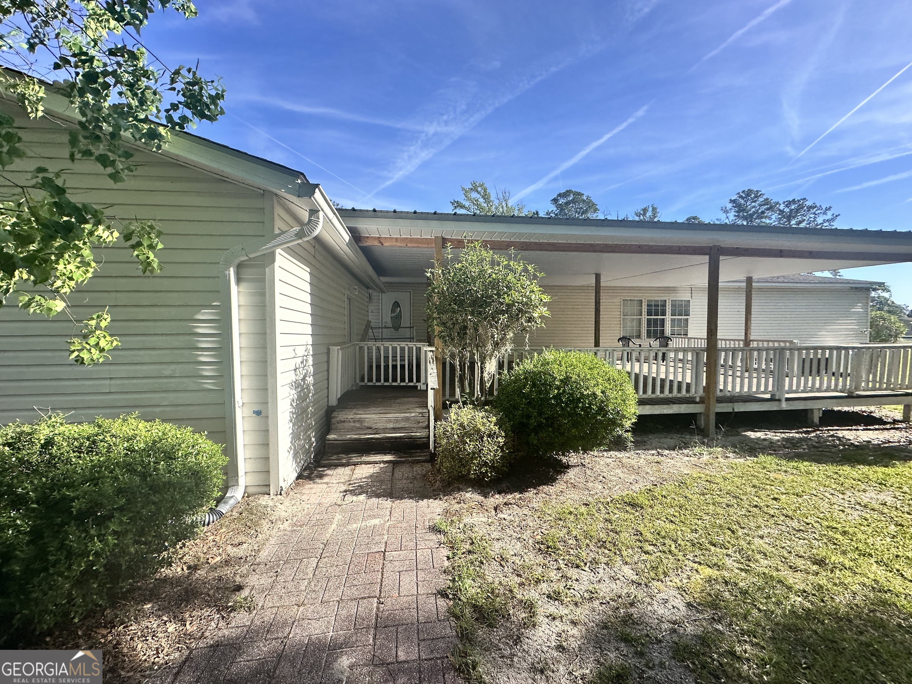 6498 Central Avenue Waycross, GA 31503 - Photo 17 of 20 a view of a house with a yard and potted plants