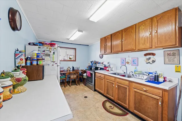 a kitchen that has a lot of cabinets a sink and a stove in it