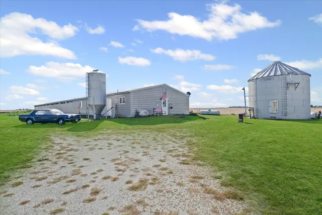 a view of a house with a yard and sitting area