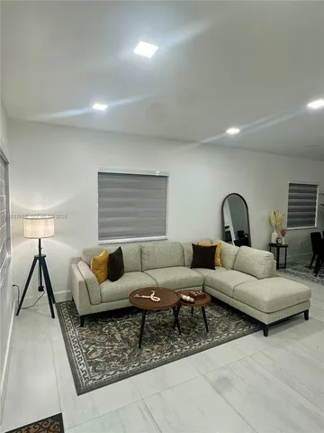 a living room with furniture and a lamp