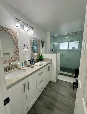 a spacious bathroom with a double vanity sink and mirror