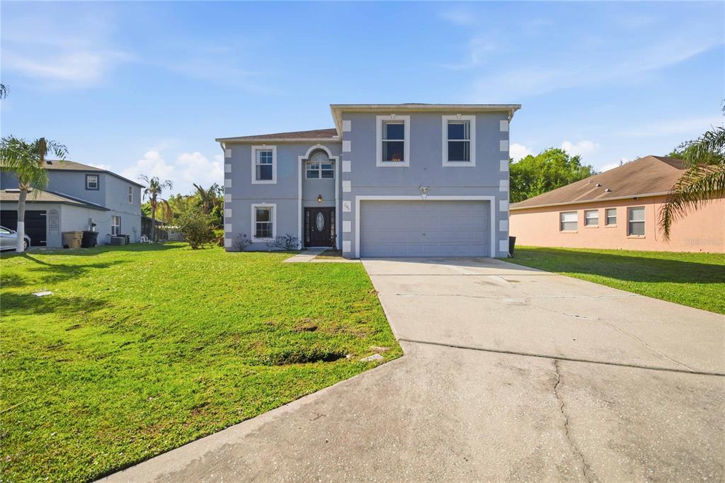 206 Taranto Way Kissimmee, FL 34758 - Photo 3 of 45 a front view of a house with a yard
