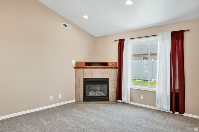 930 North 375 West Logan, UT 84321 - Photo 4 of 23 Living area with a gas fireplace, tiled surround, and wood mantel