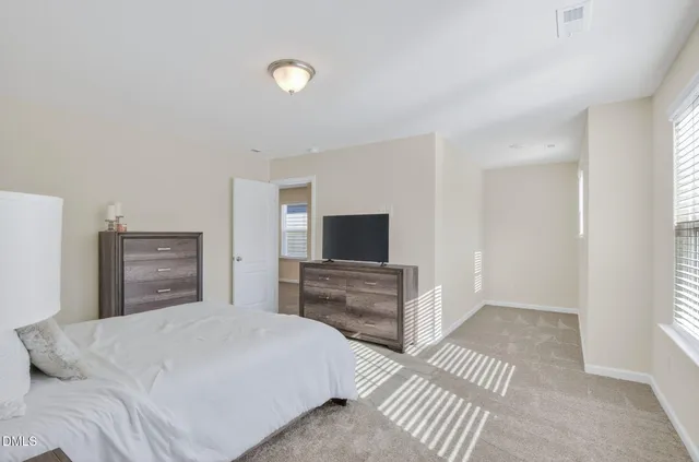 a bathroom with a shower a toilet and a tub