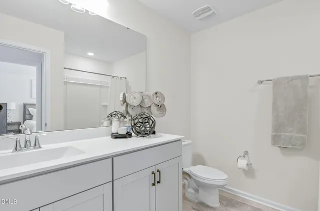 a view of a workspace with furniture and a flat screen tv