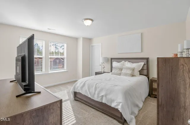 a bedroom with a bed and a ceiling fan