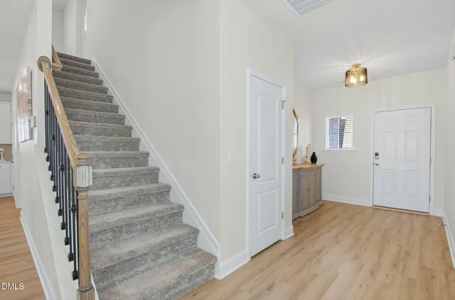 a dining room with furniture and entryway wooden floor