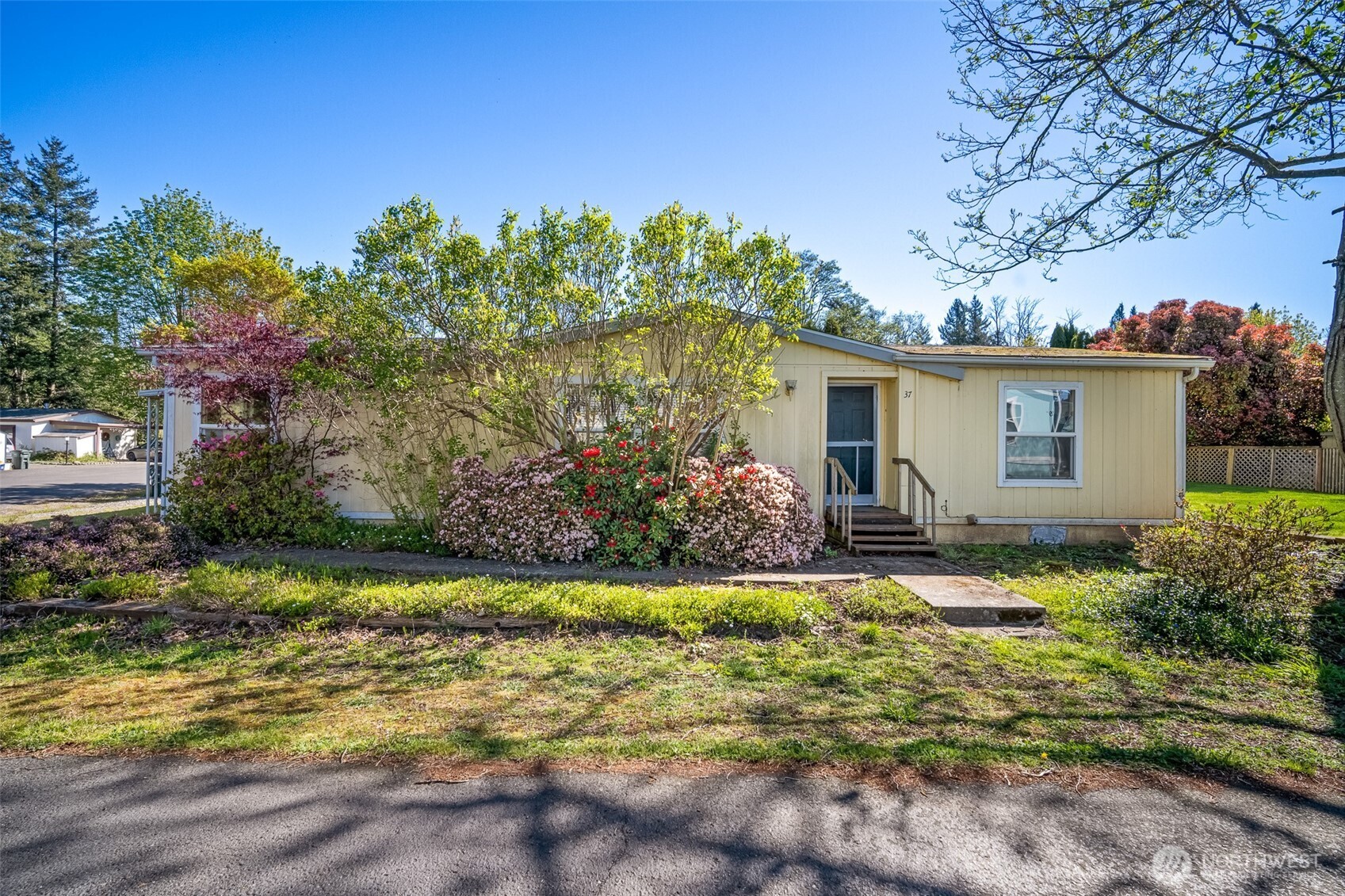 2350 Douglas Road, Unit 37 Ferndale, WA 98248 - Photo 1 of 40 a view of a house with a yard and potted plants