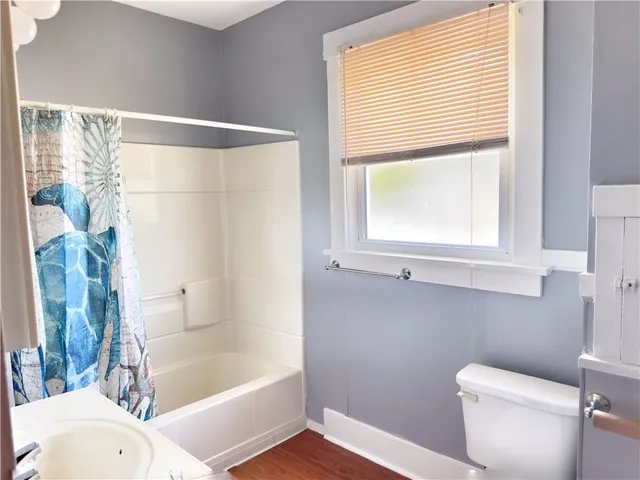 a bathroom with a bathtub and a toilet