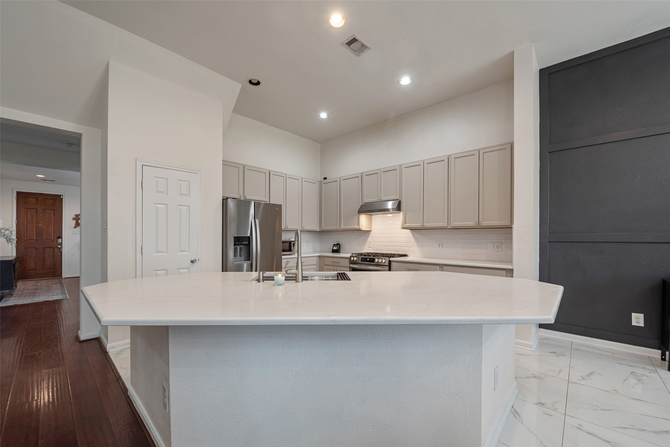 3554 Bennett Trails Drive Spring, TX 77386 - Photo 10 of 44 a large kitchen with kitchen island white cabinets and stainless steel appliances