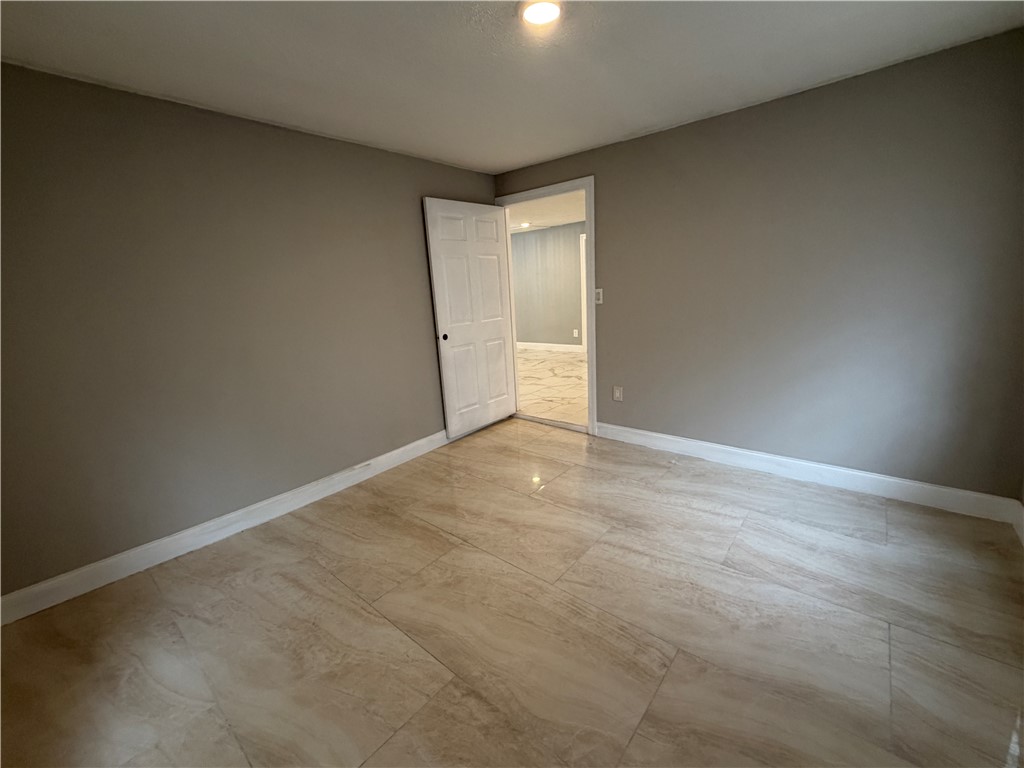 302 Sirrine Street Honea Path, SC 29654 - Photo 18 of 24 Natural light illuminates the ceramic tile floor of this inviting room, perfect for relaxation or a productive home office.