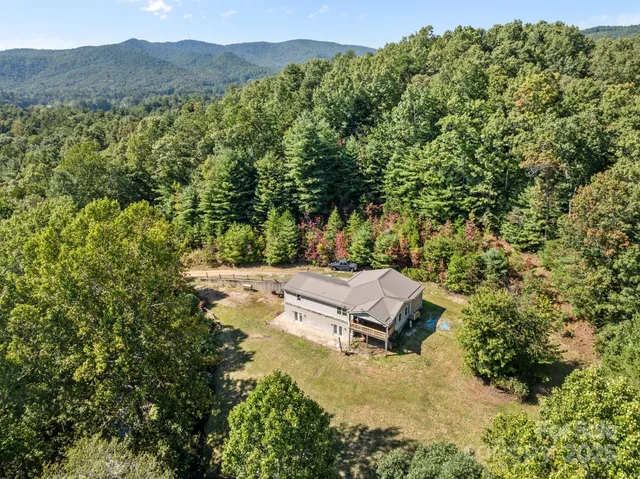 a view of a house with a yard and mountain