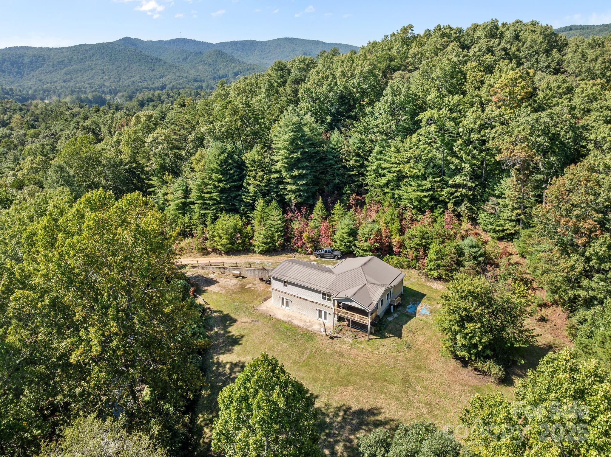 a view of a house with a yard and mountain