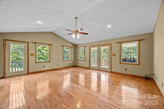 a view of a livingroom with wooden floor and a ceiling fan