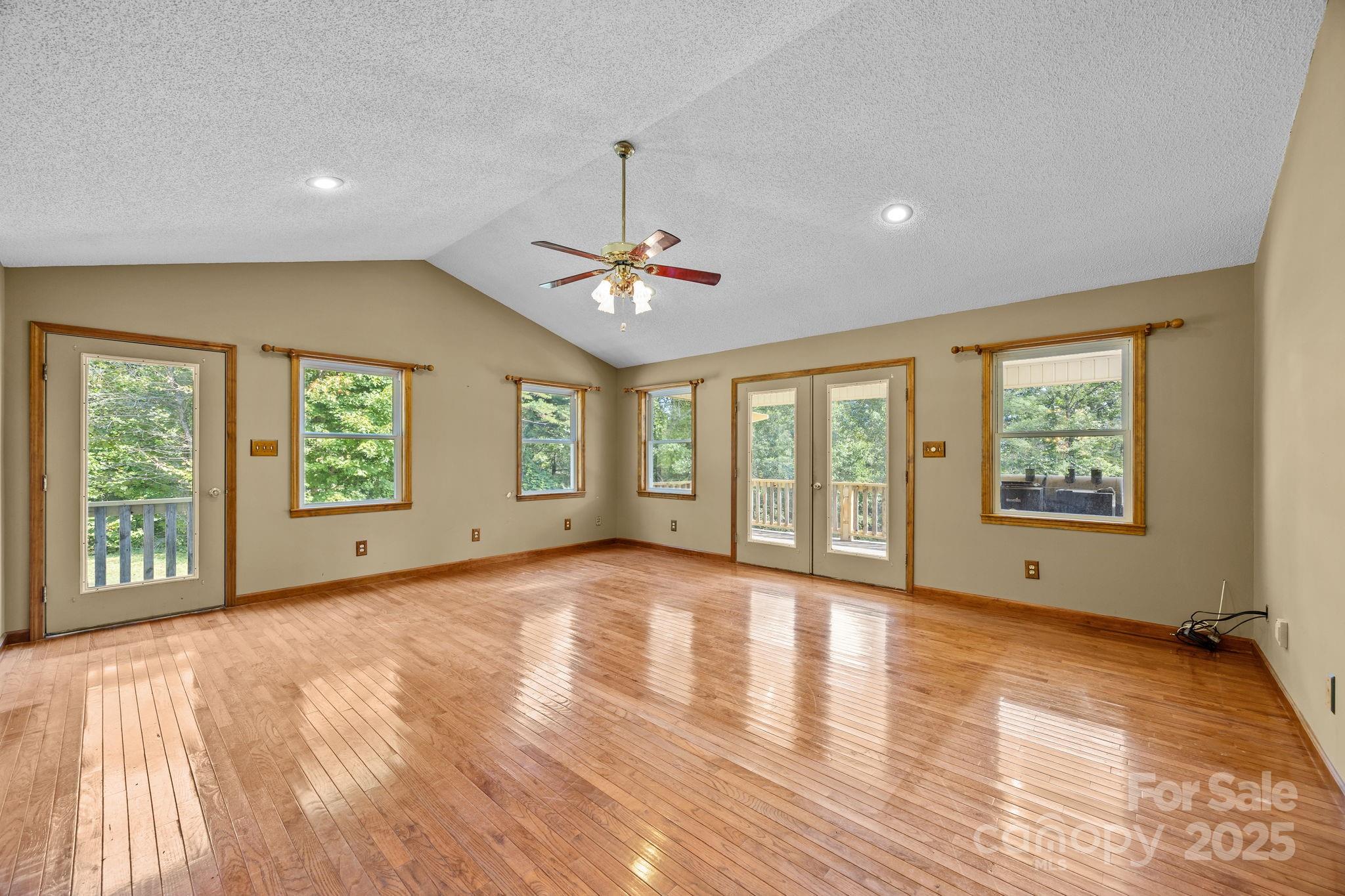 473 Eli Capps Road Zirconia, NC 28790 - Photo 12 of 37 a view of an empty room with a window and wooden floor